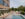 An outdoor pool is surrounded by lounge chairs with tan cushions, umbrellas and dining tables at the ROOST Kelly Drive.