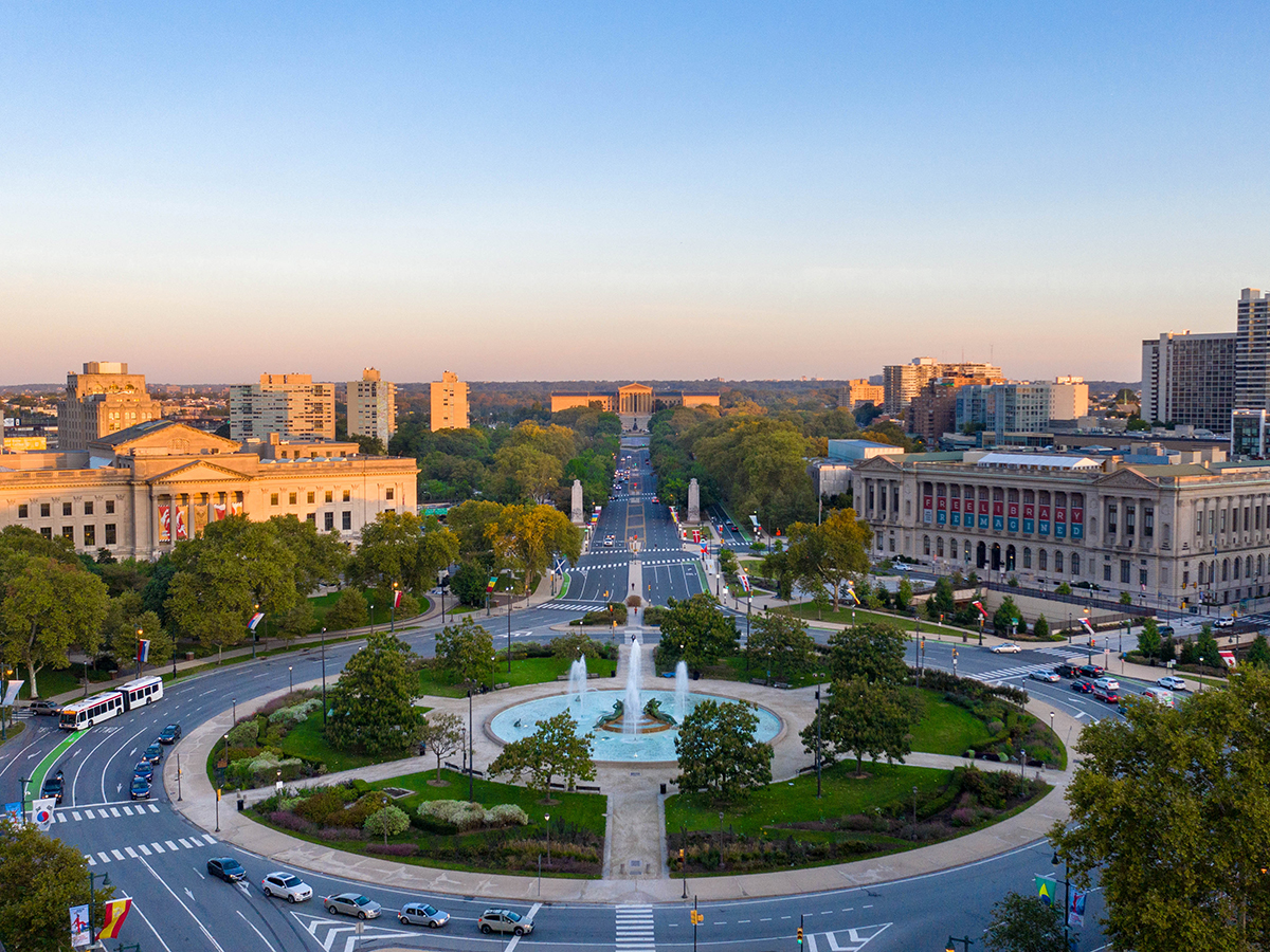 An aerial view of the Benjamin Franklin Parkway overlooking the fountain at Logan Square, the Barnes Foundation, Parkway Central Library and the Philadelphia Museum of Art.