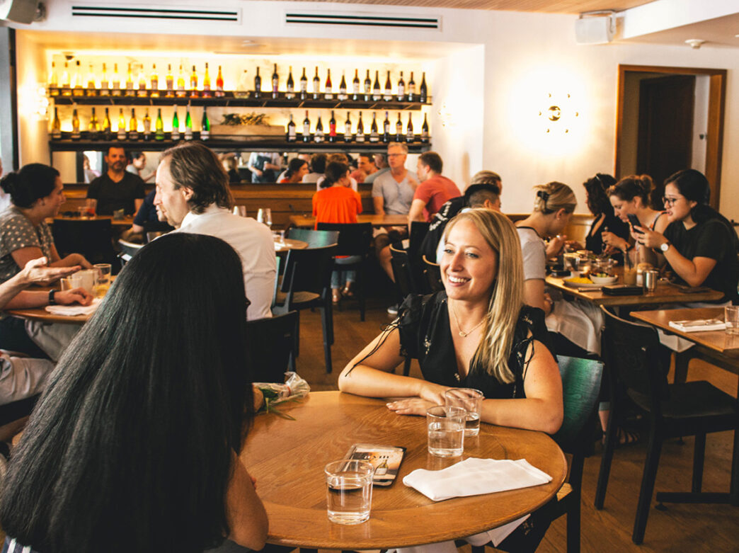 People sit at dining tables at a.kitchen in Philadelphia.