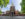 Three people walk with the back of Philadelphia's Independence Hall in the background