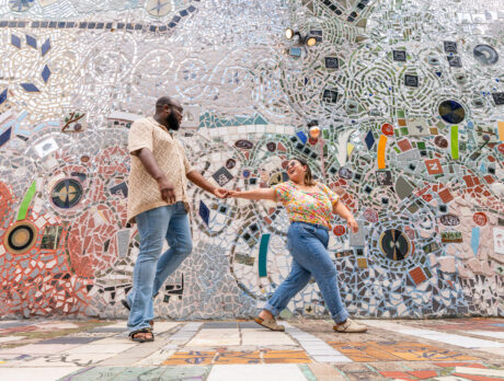 One person leads another through the mosaics at Philadelphia's Magic Gardens.