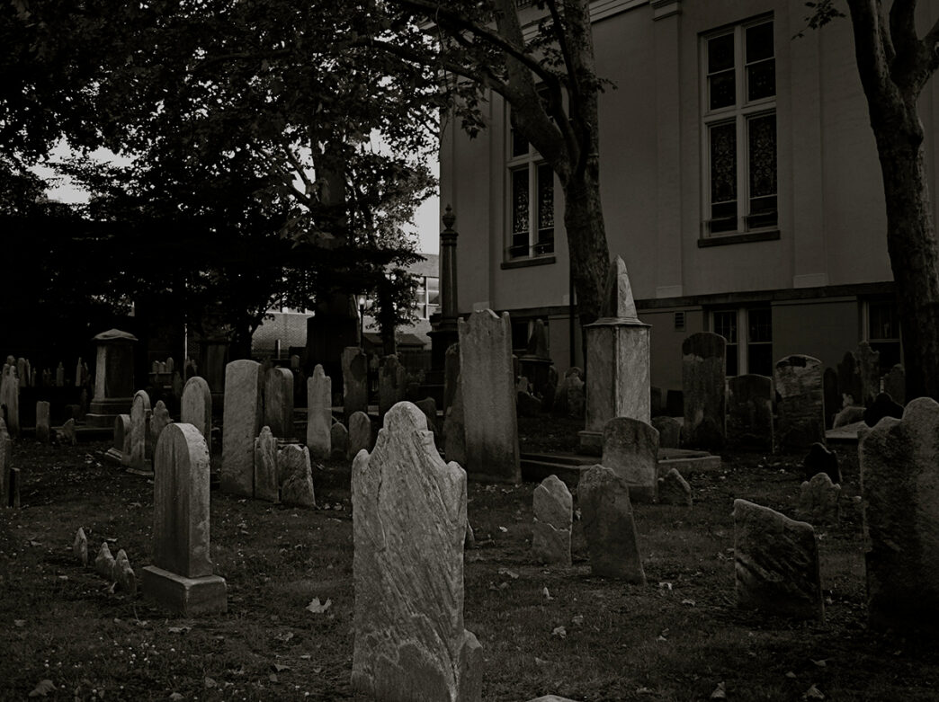 A black and white image of the headstones at the Pine Street Cemetery in Philadelphia.