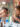 Two people stand at a table and eat cheesesteaks at Jim's Steaks on South Street. Behind them are colorful mosaics.