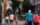 People cross a street in Philadelphia that has a rainbow crosswalk