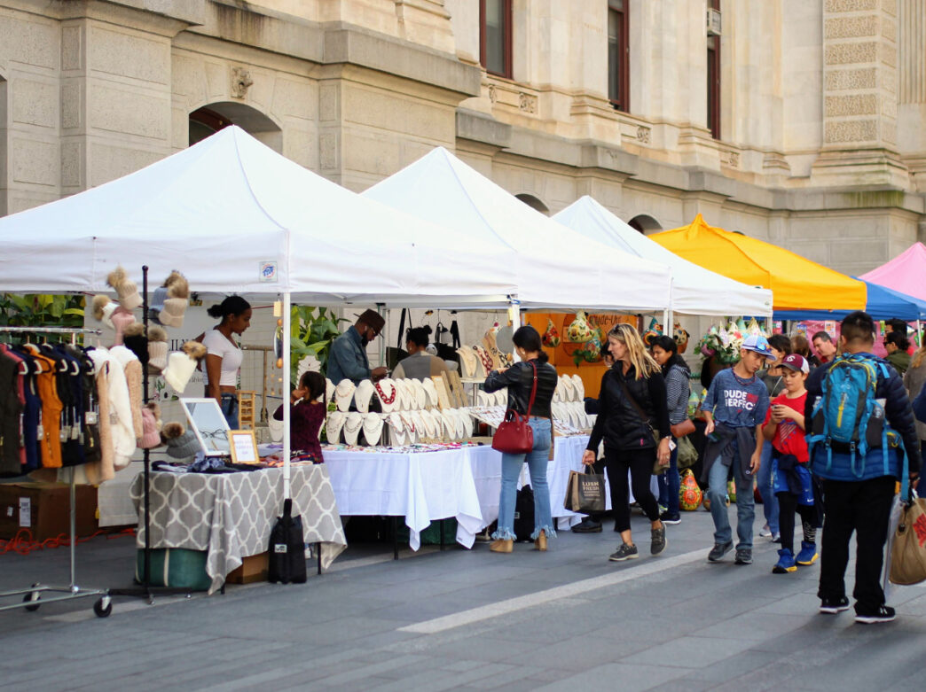 People walk through Dilworth Park and shop at vendor tents during the Fall Marketplace.