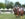 Six players wearing polo uniforms and helmets ride their horses during a match.