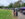 Two people wearing black outfits and witches hats walk along a path lined with arts and craft vendors at Mount Moriah Cemetery.