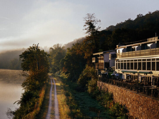 Exterior shot of the Black Bass Hotel overlooking the Delaware River and towpath.