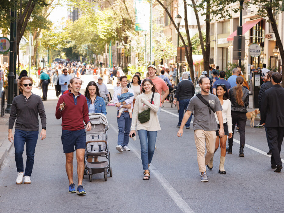 People walnut along a car-free street while enjoying Rittenhouse Square Open Streets: West Walnut.