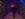 A couple stands in the center of a tunnel, surrounded by red and blue lights, at Peddler's Village.