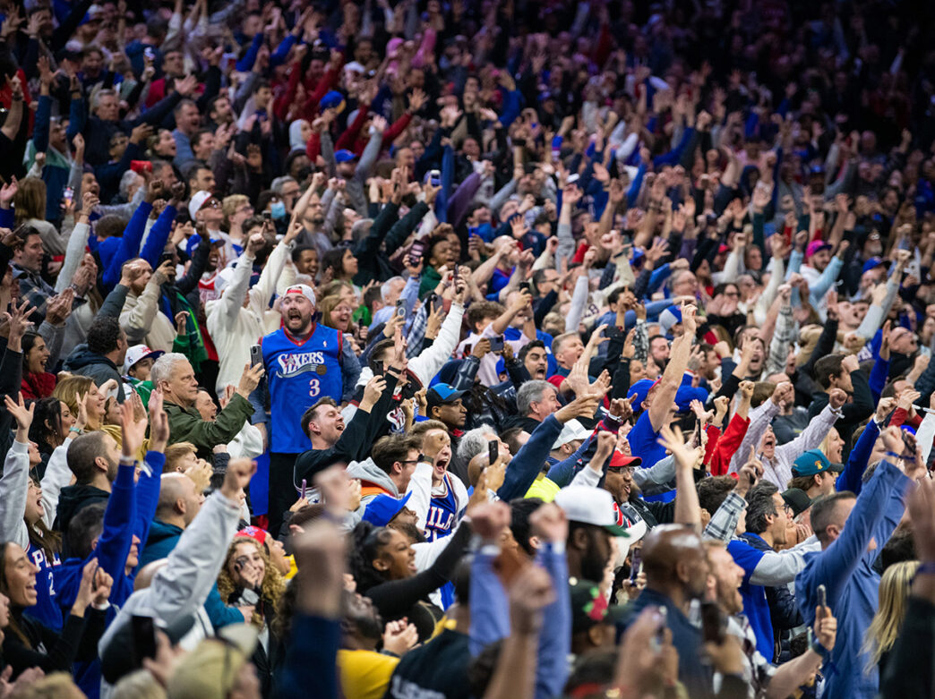 Sixers fans — many dressed in blue Sixers jerseys and T-shirts — go wild at the Wells Fargo Center.