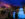People wearing coats and hats walk around Franklin Square to admire the Electrical Spectacle Light Show. Sting lights hang around the fountain and decorate the surrounding trees.