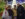 A smiling family of four poses among sparkling holiday lights and festive decorations at Independence Blue Cross Riverrink Winterfest.