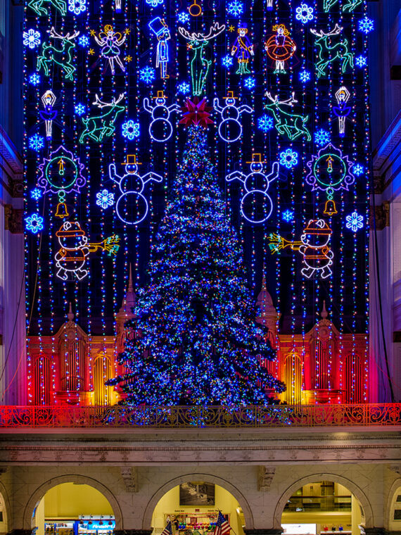 A Christmas tree and backdrop are decorated with holiday lights at Macy's Center City location.