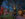 Festive holiday lights illuminate the shops and trees at Peddler's Village during a peaceful evening. Visitors stroll along the brick paths, surrounded by vibrant red, yellow, blue and green string lights and charming storefront decorations.