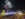 Fireworks explode in the dark sky over the Delaware River and Penn's Landing. People ice skate and watch the fireworks from Blue Cross Riverrink Winterfest.