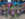 People dressed in extravagant colorful costumes and green face masks play the saxophone during the New Year's Eve Mummers Parade.