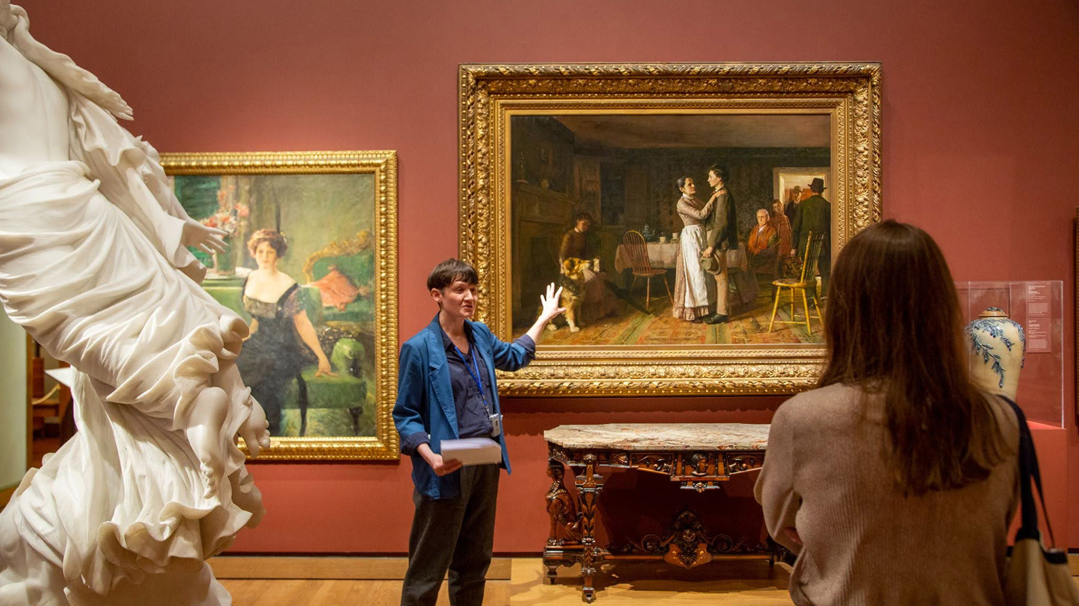 Aislinn Pentecost-Farren leads a guided tour through an art museum.