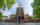 Three people walk with the back of Philadelphia's Independence Hall in the background.