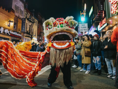 People watch a performance of a traditional lion dance during the Lunar New Year Night Parade in Chinatown.