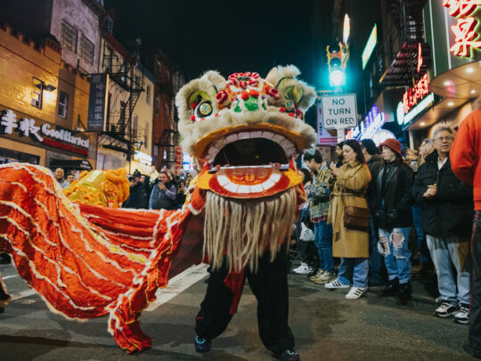 People watch a performance of a traditional lion dance during the Lunar New Year Night Parade in Chinatown.
