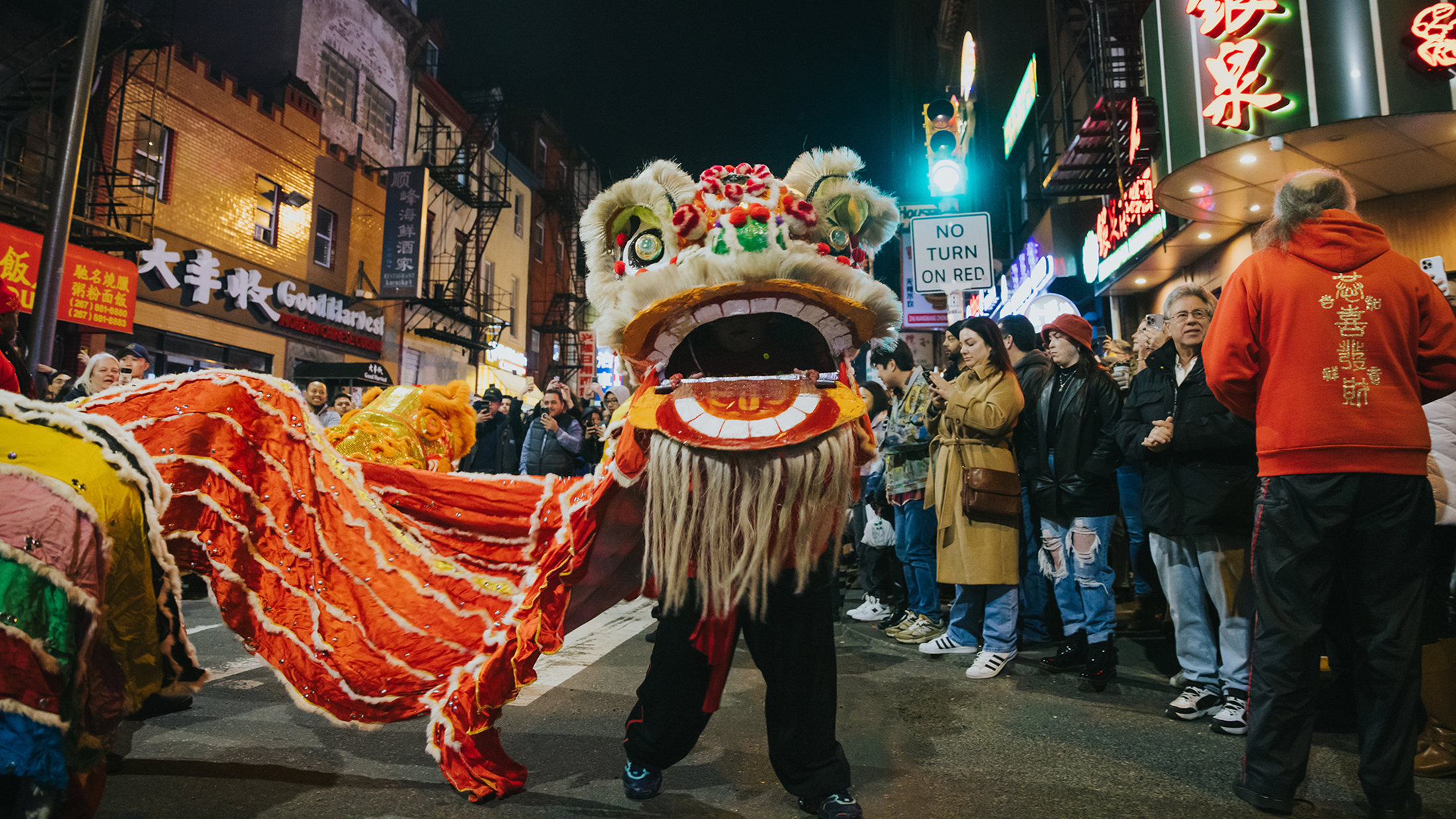 People watch a performance of a traditional lion dance during the Lunar New Year Night Parade in Chinatown.