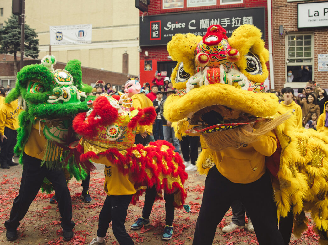 People gather to watch a performance of a traditional lion dance during the Lunar New Year Parade in Chinatown.