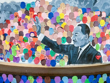 A mural of Martin Luther King Jr. at the Please Touch Museum is decorated with colorful cutout drawings.
