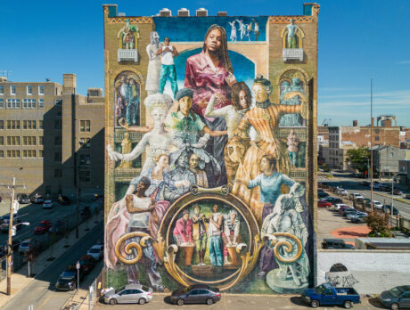 A vibrant mural titled "Common Threads" adorns the side of a tall brick building in Philadelphia and depicts a diverse group of historical and contemporary figures.