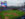 A panoramic view of the Phillies game at Citizens Bank Park showcases the vibrant green field, the towering scoreboard, and the Philadelphia skyline in the distance.