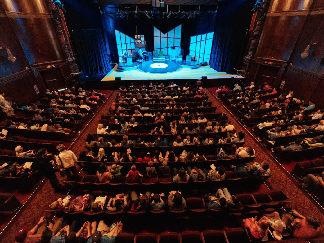 People take their seats in the theater to see a production at The Media Theatre.