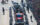 Flanked by police motorcycles, a red truck is adorned with Eagles flags and carries the team's mascot Swoop, cheerleaders and staff down the street as a crowd of fans watches.