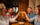 A group of four friends at a collaborative dinner at Irwin's toast their cocktails.