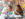 Two people stand at a table and eat cheesesteaks at Jim's Steaks on South Street. Behind them are colorful mosaics.