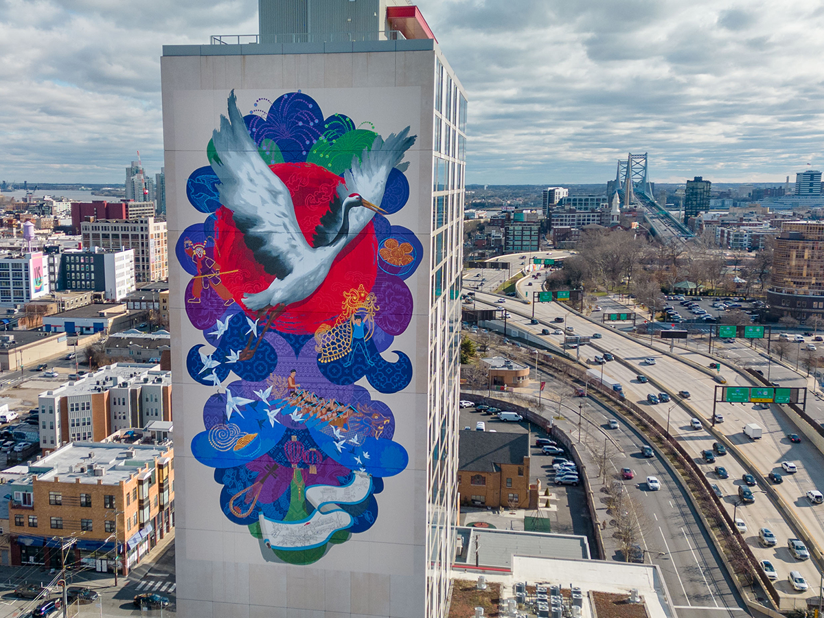A massive and vibrant mural depicts a crane spreading its wings.
