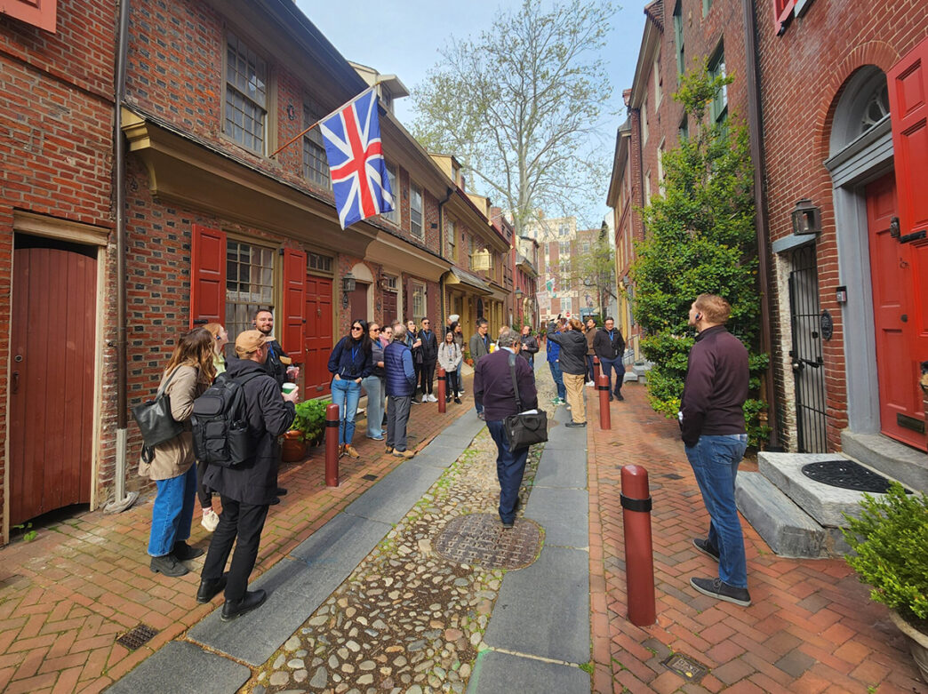 A group observes the historic homes on Elfreth’s Alley while on a Neighborhood Walking Tour of Old City.