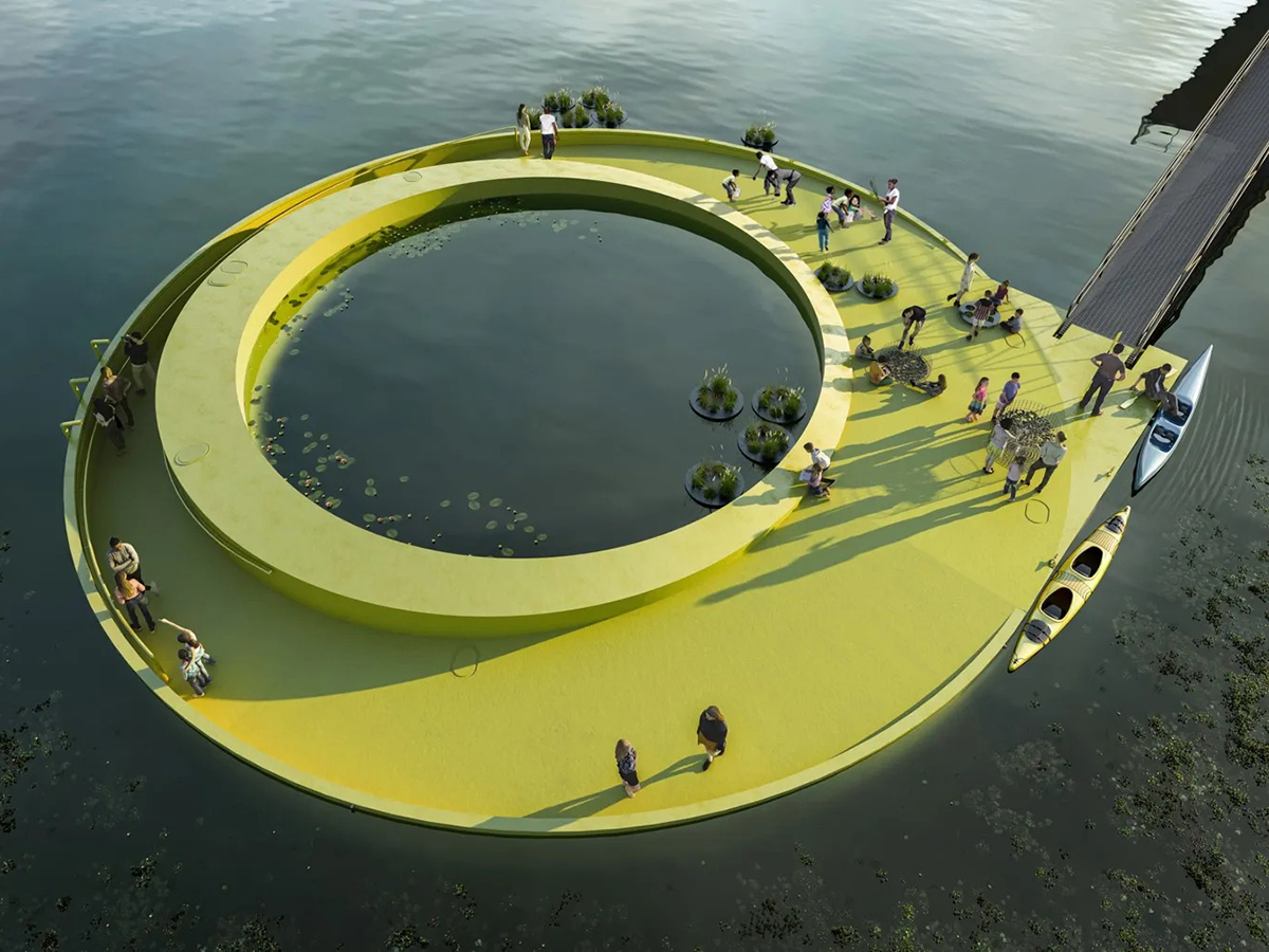 Rendering of FloatLab, a bright yellow, circular floating platform on the water, featuring greenery, interactive installations and visitors walking and kayaking around its perimeter.