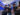 A group of players in motion-tracking suits, VR headsets and vests engage in a fully immersive virtual reality experience at Sandbox VR, surrounded by futuristic tech.