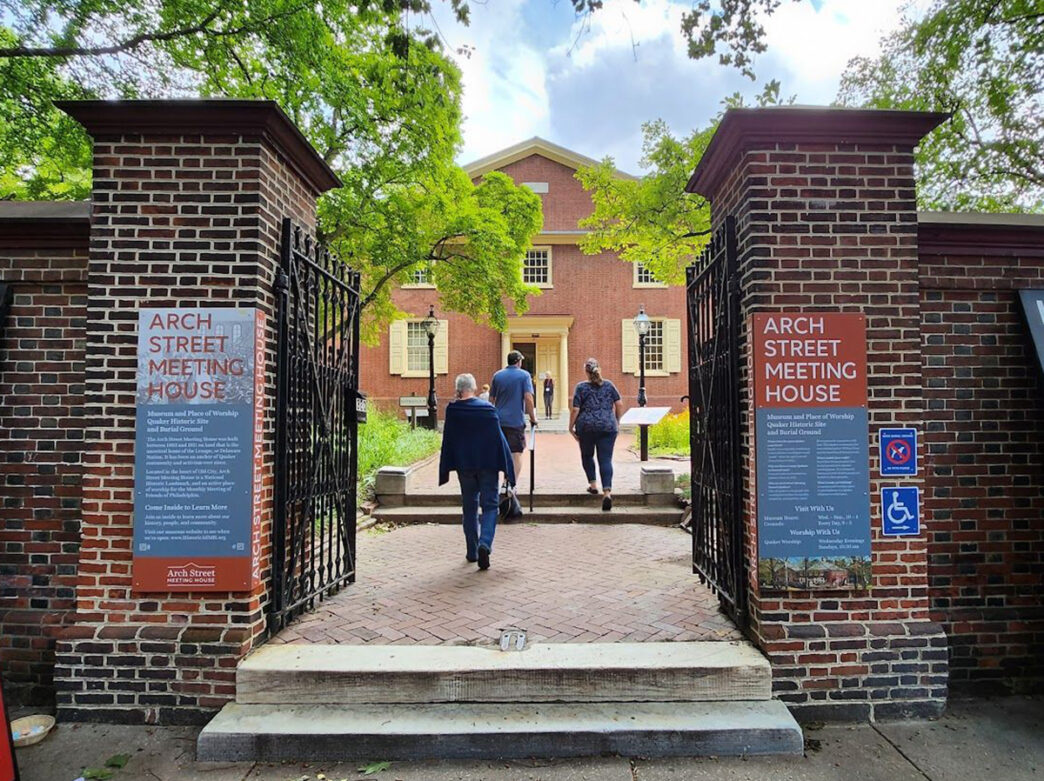 Visitors walk through the gates of Arch Street Meeting house, a historic Quaker site in Old City.