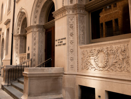 The exterior of The Curtis Institute of Music, an ornate sandstone building with stairs leading to the sidewalk.