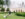 A family sits in the grass while looking up at a large fountain spraying water into the air at Longwood Gardens.