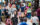 A bustling crowd fills Baltimore Avenue during the Dollar Stroll. People socialize, walk and stop for drinks.