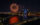A bright burst of fireworks illuminates the dark sky above the Benjamin Franklin Bridge with Philadelphia's skyline and Delaware River glowing beneath it.