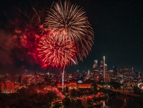 Large red and gold fireworks erupt in a dark sky over the Philadelphia Museum of Art in Philadelphia.
