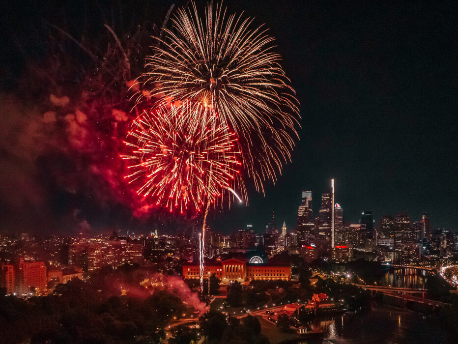 Large red and gold fireworks erupt in a dark sky over the Philadelphia Museum of Art in Philadelphia.