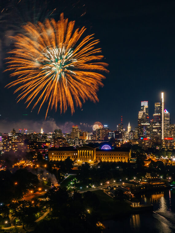A large orange and gold firework erupts over the Philadelphia Museum of Art in Philadelphia.