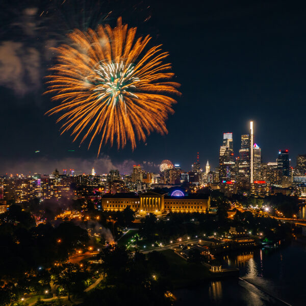 A large orange and gold firework erupts over the Philadelphia Museum of Art in Philadelphia.