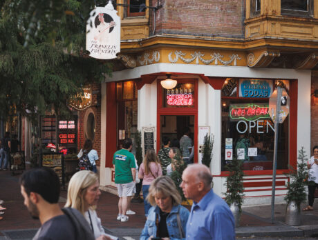 People walk and gather outside Franklin Fountain, a charming old-school ice cream shop in Old City.