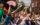 People wearing rainbow outfits and accessories clap and cheer during the Pride March and Festival in Philadelphia.