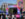 A crowd of people gather in front of a stage outside the African American Museum in Philadelphia during a Juneteenth celebration. A musical group performs on the stage.